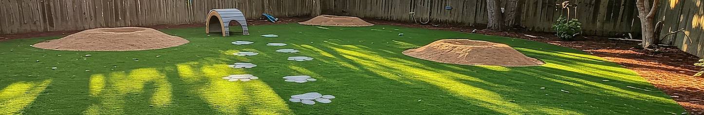 Dog Play Area with Paw Print Paths Backyard Artificial Turf Sunny Day