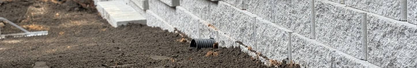 Trowel spreading concrete during patio work