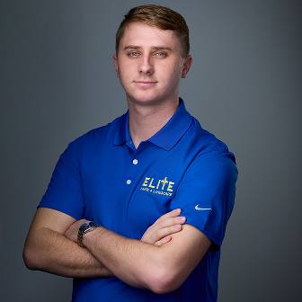 Elite Lawn team member in blue polo arms crossed Elite Lawn team member in blue polo arms crossed